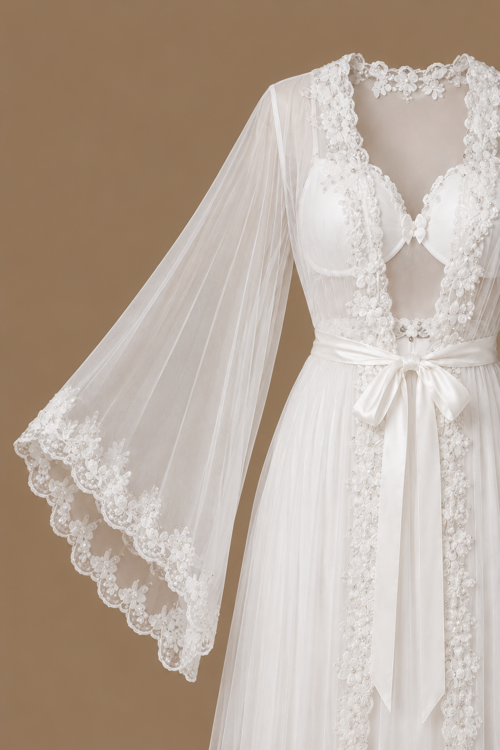 Front detail of the AHLAM bridal set showing the embellished neckline, satin tie belt and flowing sheer tulle sleeve