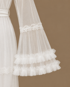 Sleeve detail of the CHAIMAE bridal lounge set showing sheer ivory tulle, floral lace trim and layered ruffles