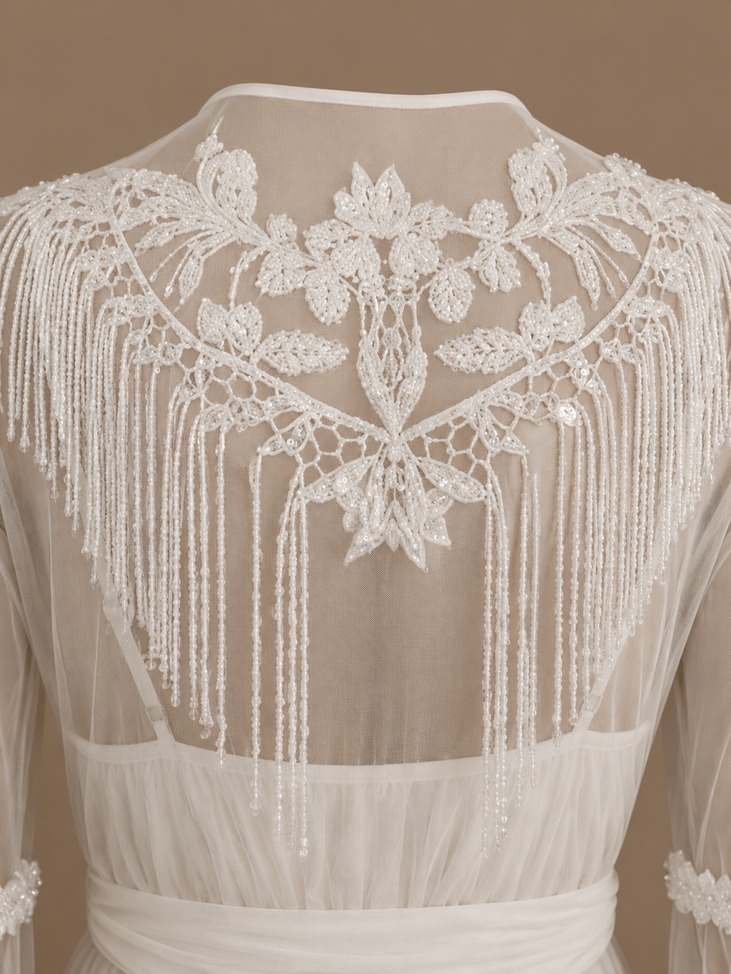 Back detail of the NOUR ivory bridal set with floral embroidery and cascading beaded fringe on sheer tulle