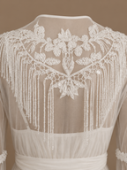 Back detail of the NOUR ivory bridal set with floral embroidery and cascading beaded fringe on sheer tulle
