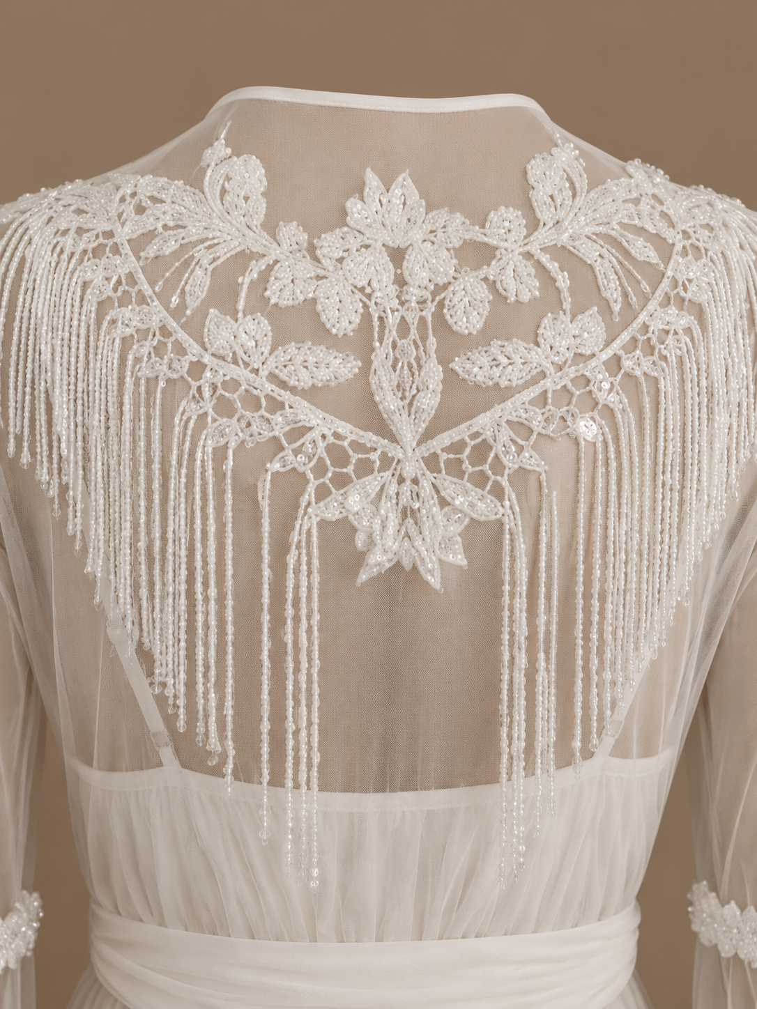 Back detail of the NOUR ivory bridal set with floral embroidery and cascading beaded fringe on sheer tulle