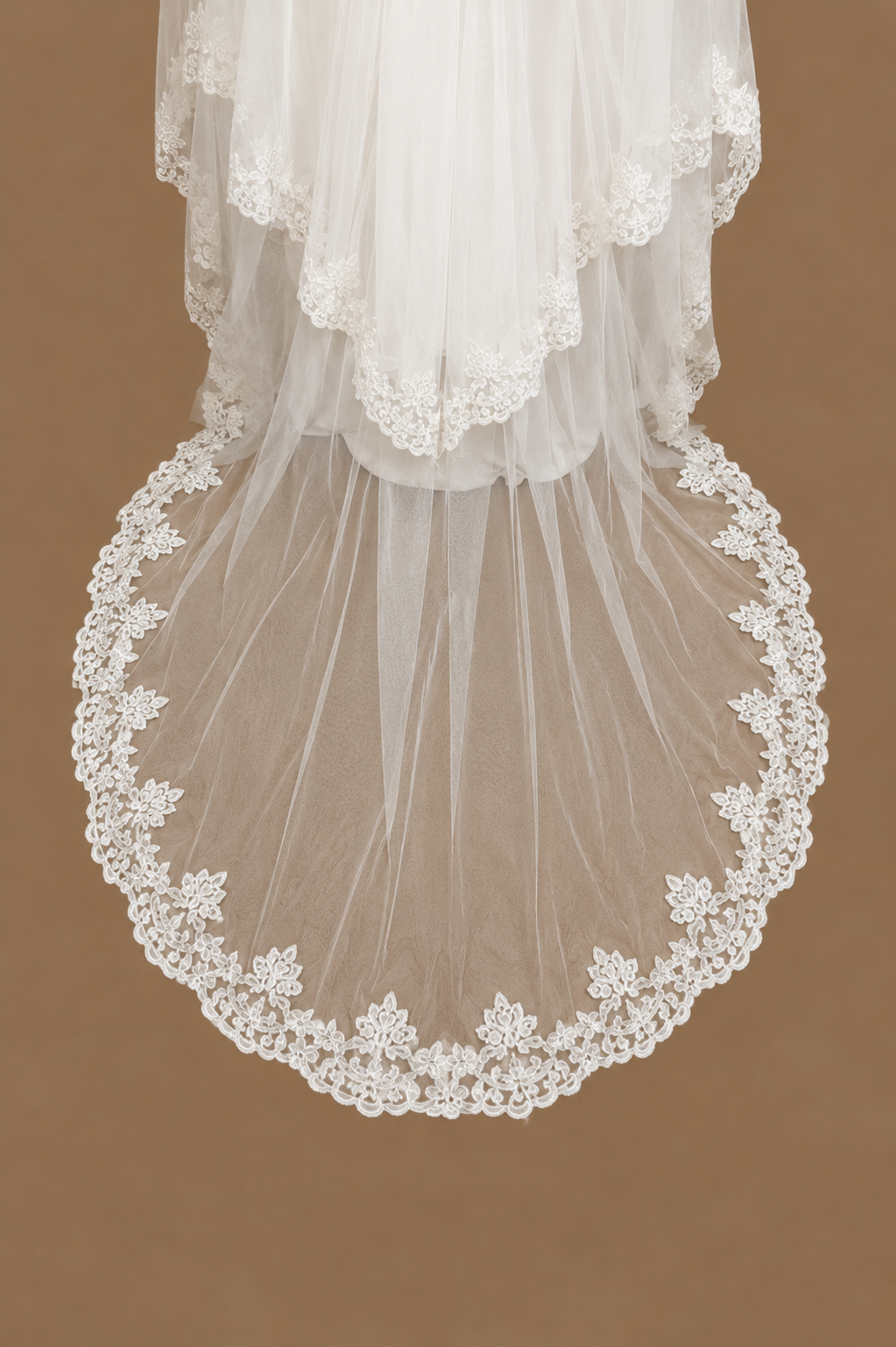Close-up of the SABAH ivory bridal set showing the sheer tulle train finished with intricate lace edging
