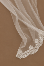 Close-up of the SABAH ivory bridal set showing delicate sheer tulle fabric finished with intricate lace edging