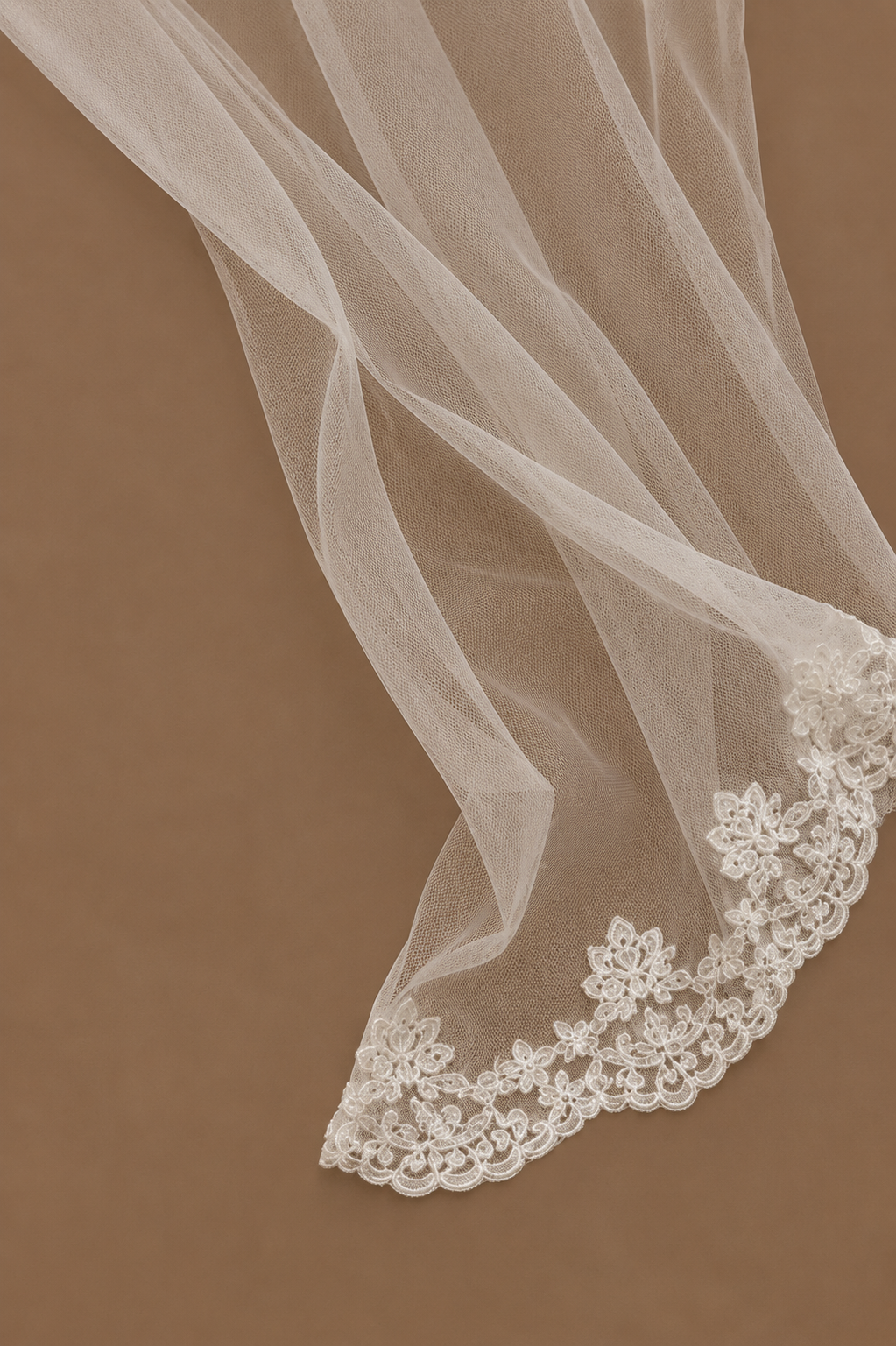 Close-up of the SABAH ivory bridal set showing delicate sheer tulle fabric finished with intricate lace edging