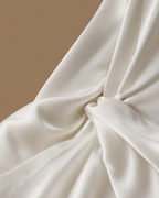 Fabric detail of the SANAE ivory satin bridal kimono showing the smooth, lustrous finish