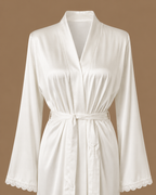 Front detail of the SANAE ivory satin bridal kimono with tie belt and lace-trimmed sleeves